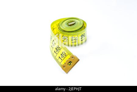 Yellow measuring tape isolated on white background close-up Stock Photo