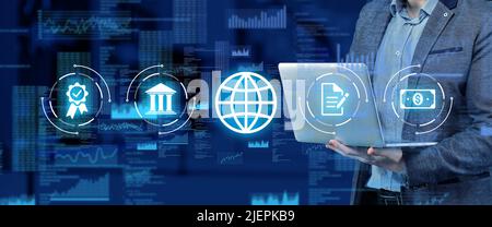 The concept of global business around the world. Abstract holographic icons on the background of a person with a laptop Stock Photo