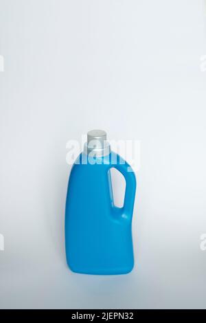 Blue plastic bottle stands on white background. Conditioner or liquid powder for washing. Capacity with space for copying. Layout for logo application Stock Photo