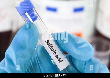 sulfuric acid in test tube used in laboratory and industry Stock Photo