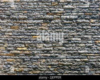 Grey Rough Stone wall texture. Part of old rocky hand crafted background with copy space. Walls made of natural bricks. High quality photo, horizontal Stock Photo