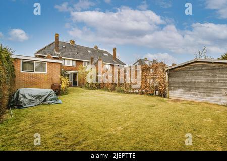 Simple small patio with small garden near wooden fence Stock Photo