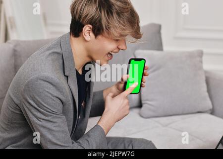 Handsome caucasian young man using phone at home Stock Photo