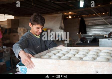 Months after establishing the second largest Refugee Camp in the World, Al Za'atari, just south of the Syrian Jordan Border, Refugees of the Civil War in their Country started up Economic Activities to support themselves and their Families. This 'Street' inside the Main Camp is called' Champs Elisee'. Al Za'atari, Al Mafraq, Jordan. Stock Photo