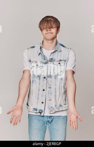 Handsome young man with trendy hairstyle posing Stock Photo