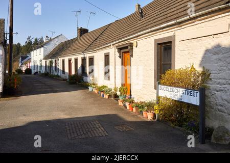 A row of traditional colourfully painted cottages in Moffat Stock Photo