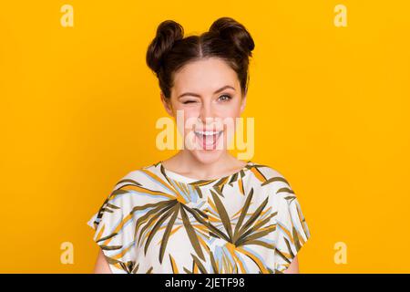 Photo of excited pretty lady dressed print t-shirt smiling winking open mouth isolated yellow color background Stock Photo