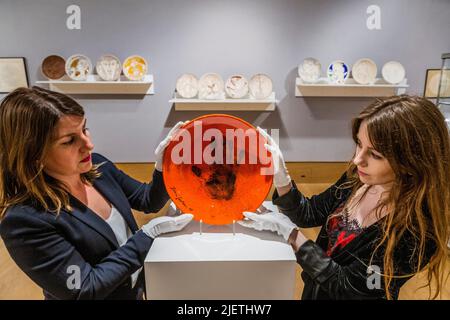 London, UK. 28th June, 2022. Le Main de Poete, Est on request, and other Ceramic plates - A preview of Bonhams' Jean Cocteau and the Madeline-Jolly Workshop sale in New Bond Street. The sale takes place on 29 September 2022, in Paris. Credit: Guy Bell/Alamy Live News Stock Photo