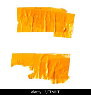 Two pieces of an old torn yellow adhesive tapes isolated on white Stock Photo