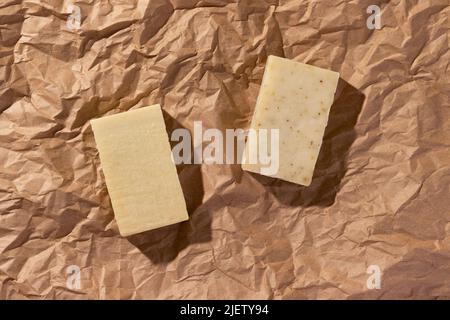 Natural handmade soaps on brown crumpled, wrinkled recycle craft paper background, top view. Zero waste, eco friendly vegan soap bars Stock Photo
