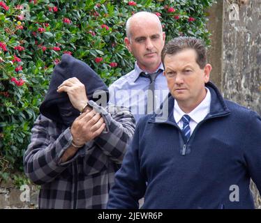 Suspect being led away from court in handcuffs Stock Photo