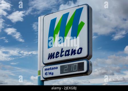 Cuneo, Italy, - June 27, 2022: Metano (methane) sign pole on Italian gas station over blue sky and clouds. Display euro price per kilogram, increase i Stock Photo