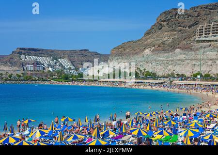 Holidaymakers on Playa de los Amadores, bathing beach close to Puerto Rico, Grand Canary, Canary islands, Spain, Europe, Atlantic ocean Stock Photo