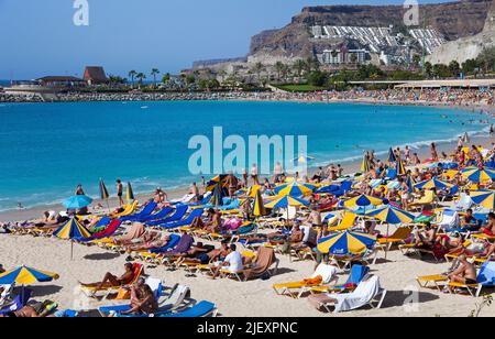 Holidaymakers on Playa de los Amadores, bathing beach close to Puerto Rico, Grand Canary, Canary islands, Spain, Europe, Atlantic ocean Stock Photo