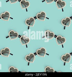 Realistic posh heart shaped sunglasses decorated with pearls over turquoise background. Seamless pattern Stock Vector