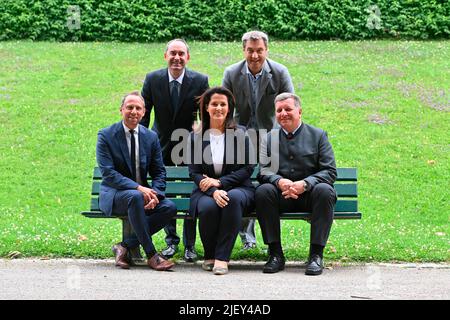 Group picture on a wooden bench from left to right: Hubert AIWANGER (free voters, Bavarian Minister for Economic Affairs), Markus SOEDER (Prime Minister of Bavaria and CSU Chairman), front from left: Thorsten GLAUBER (Environment Minister), Michaela Kaniber and Christian BERNREITER (State Minister for Housing ,construction and transport). Press conference of the Bavarian State Government on June 28th, 2022 in the courtyard garden of the Bavarian State Chancellery in Munich. Stock Photo
