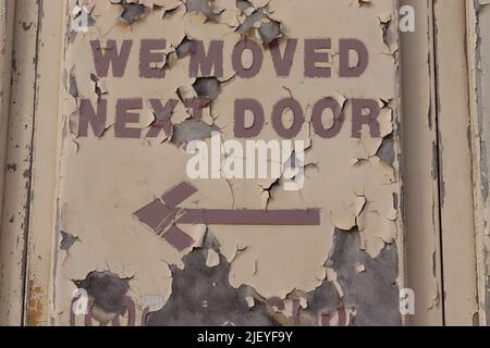 Vinyl lettering on a painted door, weathered  by Mediterranean sun, Xaghra, Gozo Stock Photo