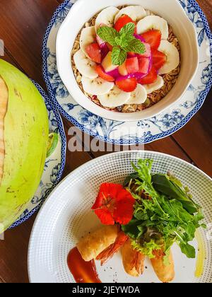 Healthy Delicious Breakfast Including Smoothie Bowl With Fruits And Berries And Asian Spring Rolls With Flower Decoration Stock Photo