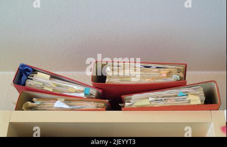 Forgotten files on top of a book shelf,red tape, bureaucracy,aministration,business concept. Free copy space. Stock Photo