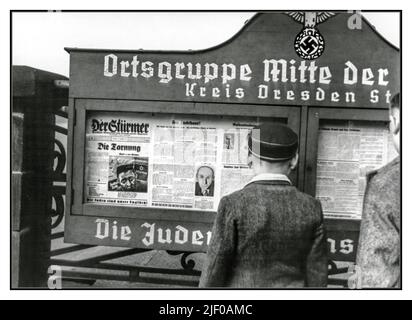 1930s Der Sturmer virulent anti semitic Nazi propaganda newspaper in a village news display cabinet, the newspaper owned and produced by Julius Streicher, an Adolf Hitler supporter enthusistic member of the Nazi Party and a passionate anti semite, subsequently executed for war crimes at Nuremberg Stock Photo