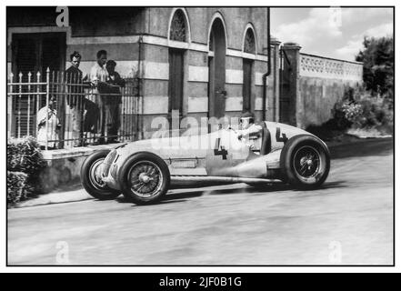 Driver Von Brauchitsch (n ° 4) in a 'Silver Arrow' Mercedes at the Circuit del Montenero.   Manfred Georg Rudolf von Brauchitsch (15 August 1905 – 5 February 2003) was a German auto racing driver who drove for Mercedes-Benz in the famous 'Silver Arrows' of Grand Prix motor racing in the 1930s. Montenero Circuit, official name: Circuito del Montenero or sometimes referred to simply as 'the Livorno Circuit', was a Grand Prix motor racing road course located at the southern outskirts of Livorno, a city on the mediterranean coast of the Tuscany region in Italy. Stock Photo