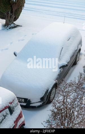 Cars parked on a driveway covered in snow viewed from above, Fife, Scotland. Stock Photo