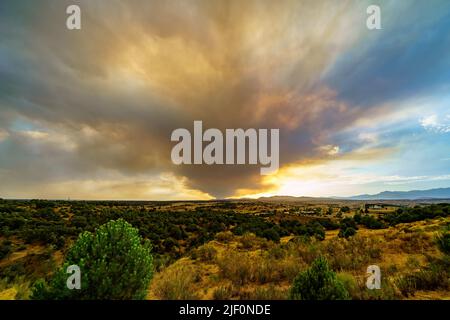 Large column of smoke over the sky from a forest fire in the mountains of Madrid Spain. Stock Photo