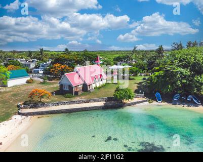 Aerial view of Notre Dame Auxiliatrice Church with distinctive red roof at Cap Malheureux, Mauritius, Indian Ocean Stock Photo