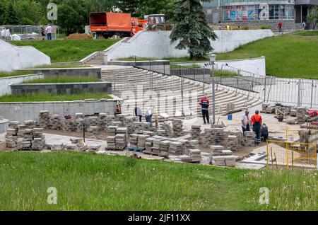 Moscow, Russia - June 17. 2022. Workers laying tiles on a sidewalk Stock Photo