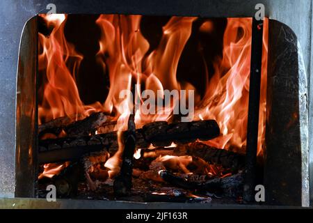 Fire flames from a wood stove fire isolated on a black background Stock Photo