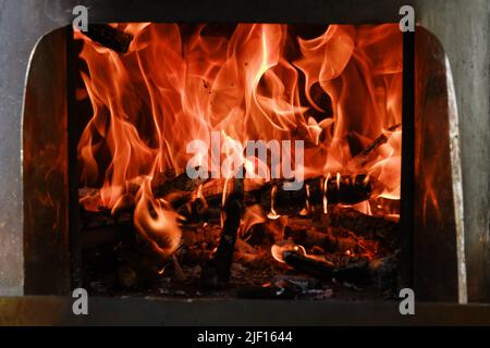 Fire flames from a wood stove fire isolated on a black background Stock Photo