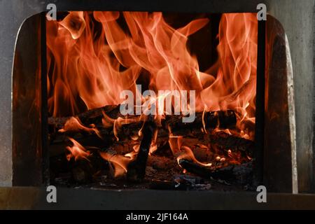 Fire flames from a wood stove fire isolated on a black background Stock Photo