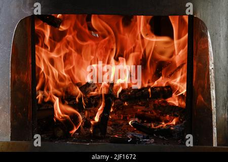Fire flames from a wood stove fire isolated on a black background Stock Photo