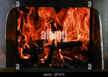 Fire flames from a wood stove fire isolated on a black background Stock Photo