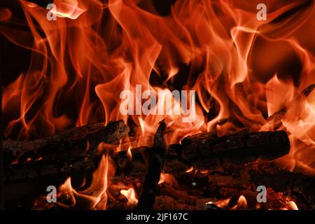 Fire flames from a wood stove fire isolated on a black background Stock Photo