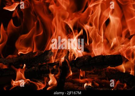 Fire flames from a wood stove fire isolated on a black background Stock Photo