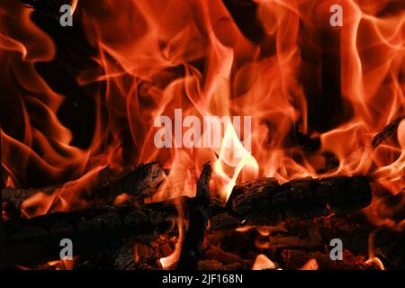 Fire flames from a wood stove fire isolated on a black background Stock Photo