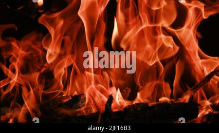Fire flames from a wood stove fire isolated on a black background Stock Photo
