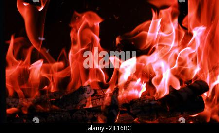 Fire flames from a wood stove fire isolated on a black background Stock Photo