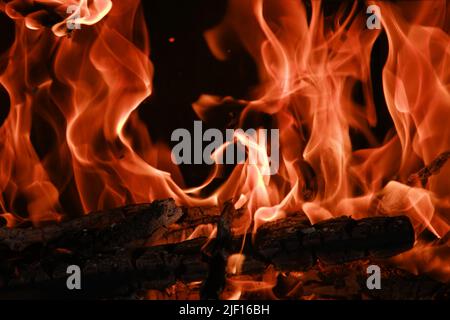 Fire flames from a wood stove fire isolated on a black background Stock Photo