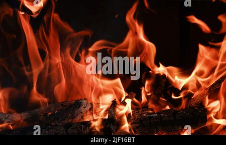 Fire flames from a wood stove fire isolated on a black background Stock Photo
