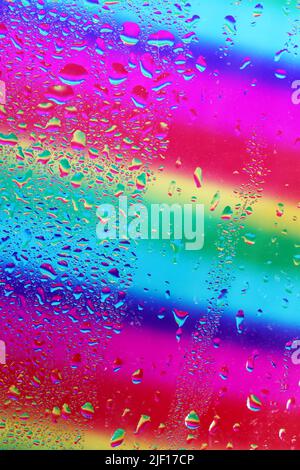 Water drops on glass colorful background Stock Photo