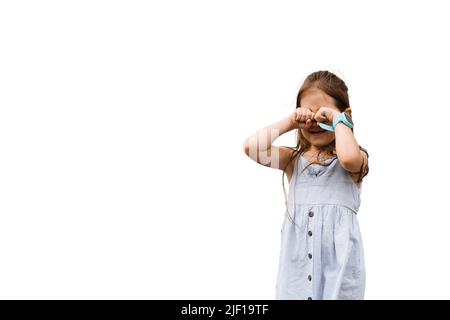 Weeping kid closes her face with hands. Adorable upset child girl crying on white background. Toddler problems Stock Photo