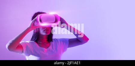 Brunette woman wearing vr glasses, panorama with copy space Stock Photo