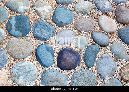 Cobblestone pavement on the road as creative background texture Stock Photo