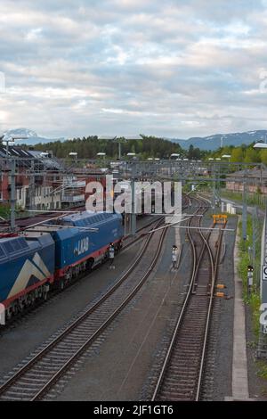 Large trainloads of iron ore from Kiruna arriving in Narvik, meeting empty train returning eastward. Stock Photo