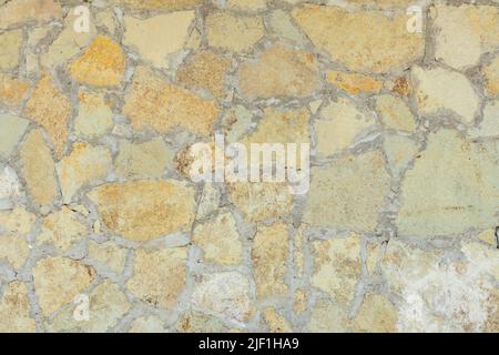 Solid yellow and beige stone wall suitable for background Stock Photo