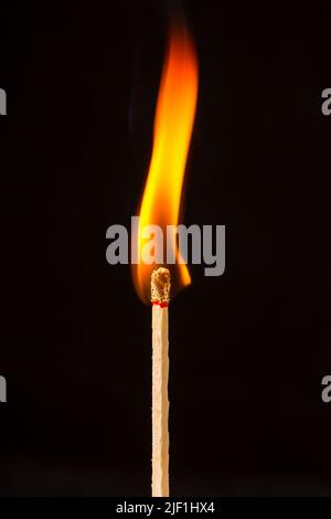 Burning matchstick on black background Stock Photo