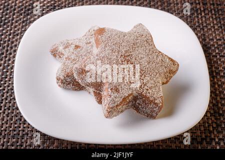 delicious chocolate flavor cookie sprinkled with sugar late night snack placed on a white plate homemade Stock Photo