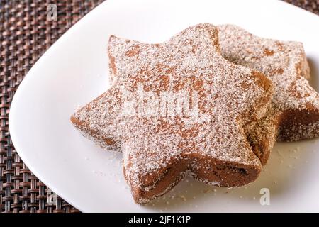 delicious chocolate flavor cookie sprinkled with sugar late night snack placed on a white plate homemade Stock Photo